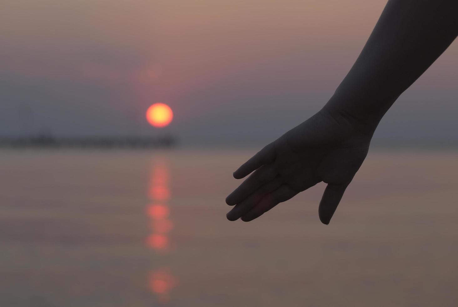 Hand at sunset photo