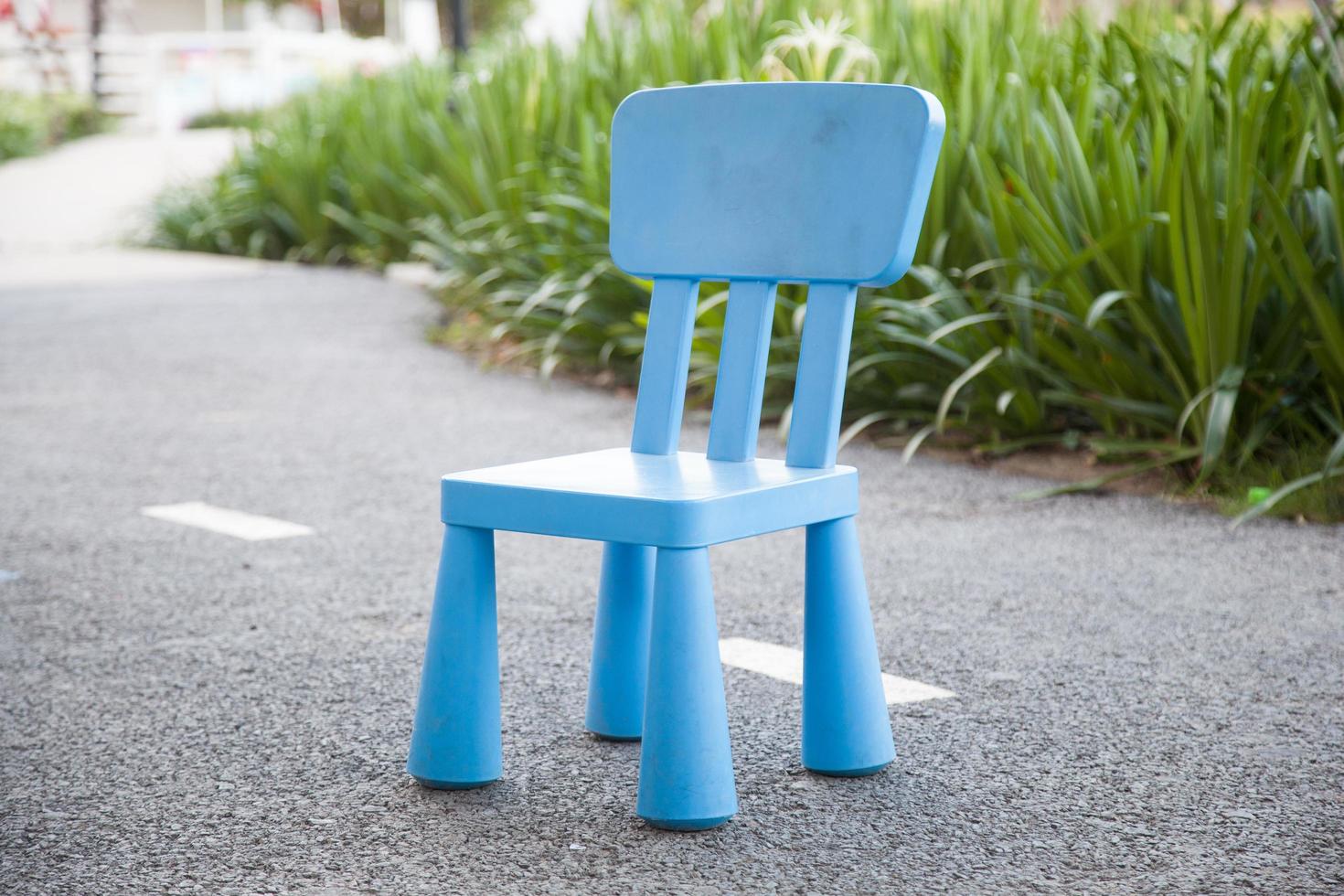 Blue plastic chair in the park photo