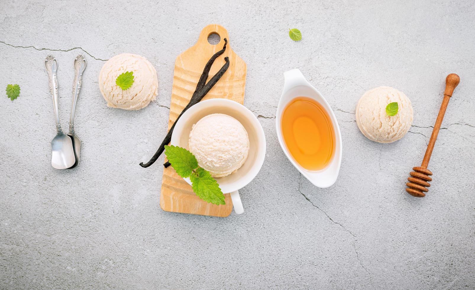 Vanilla ice cream flavor in bowl with vanilla pods and honey photo