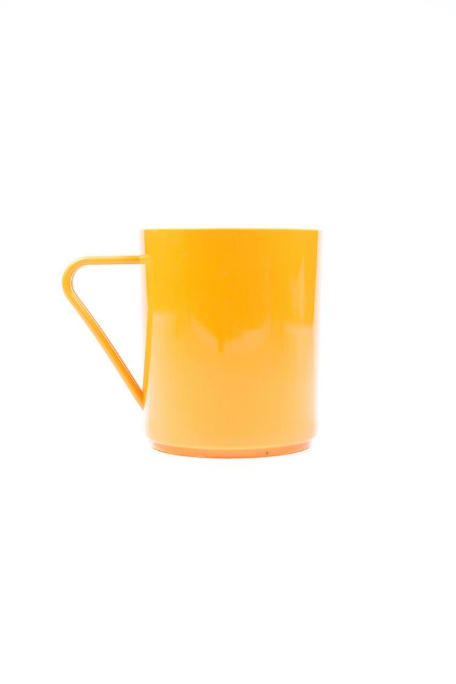 Orange plastic cup on white background photo