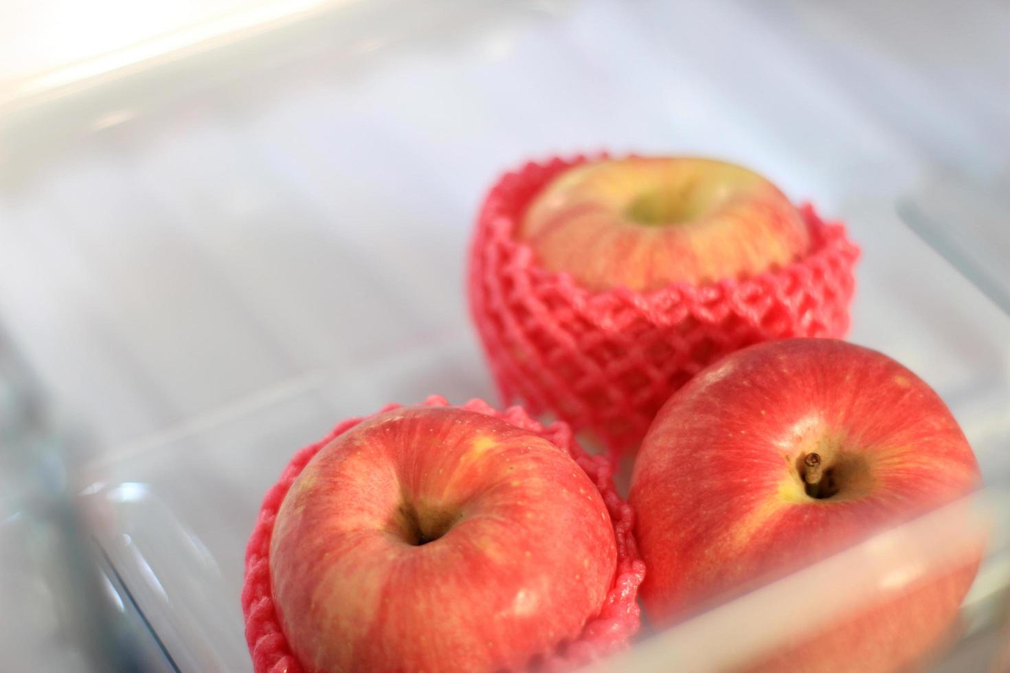 Fresh apples in refrigerator photo