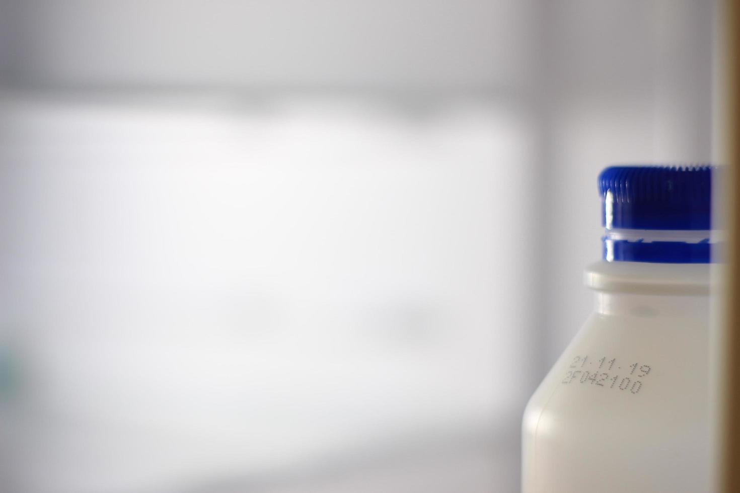 Milk bottle in refrigerator photo