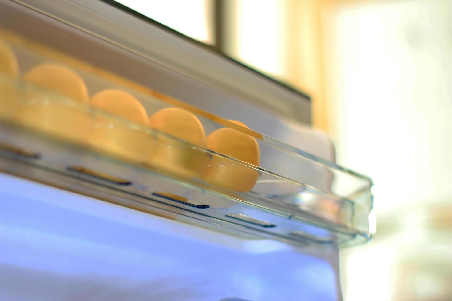 Eggs on shelf of refrigerator photo