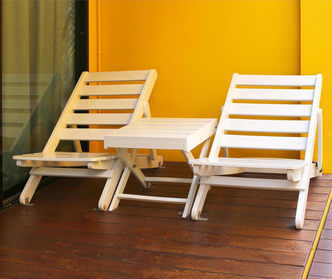 White chairs and table on deck photo