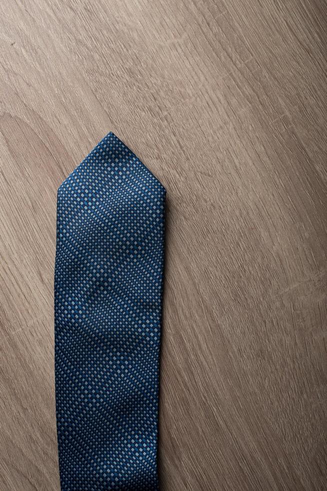 Blue tie Isolated on wooden background photo