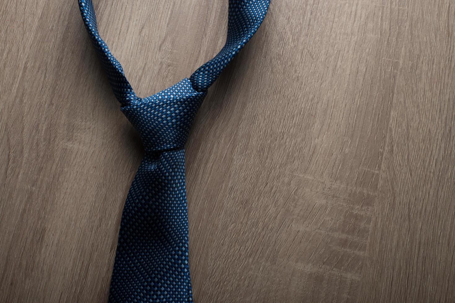 Blue tie Isolated on wooden background photo