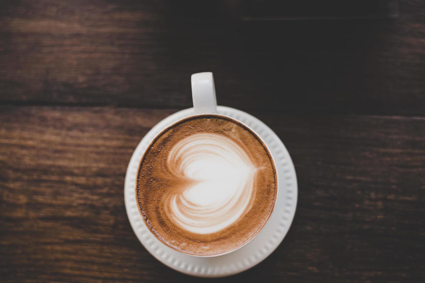 Top view of vintage latte art coffee with heart shape photo