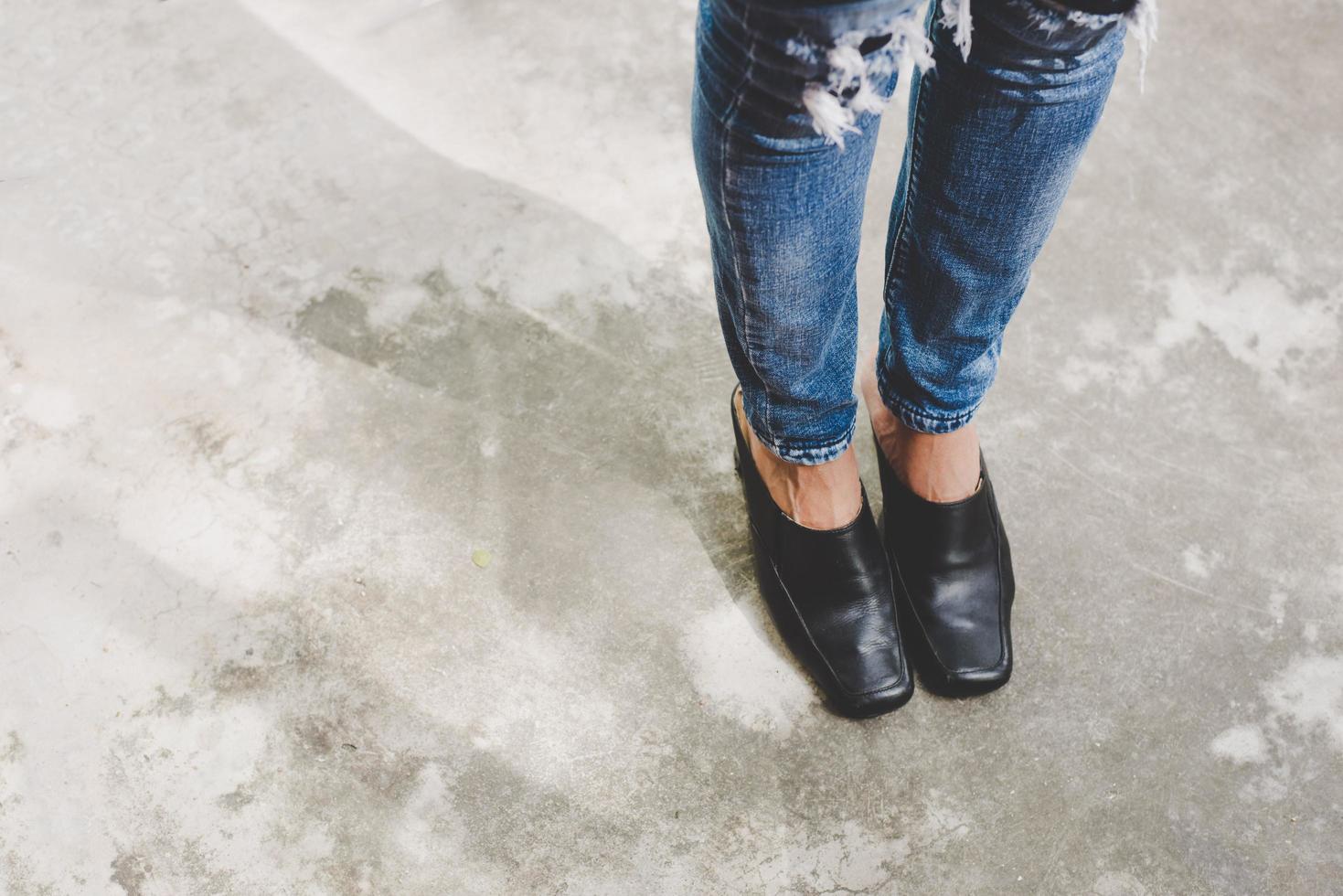 Woman's legs in denim jeans photo