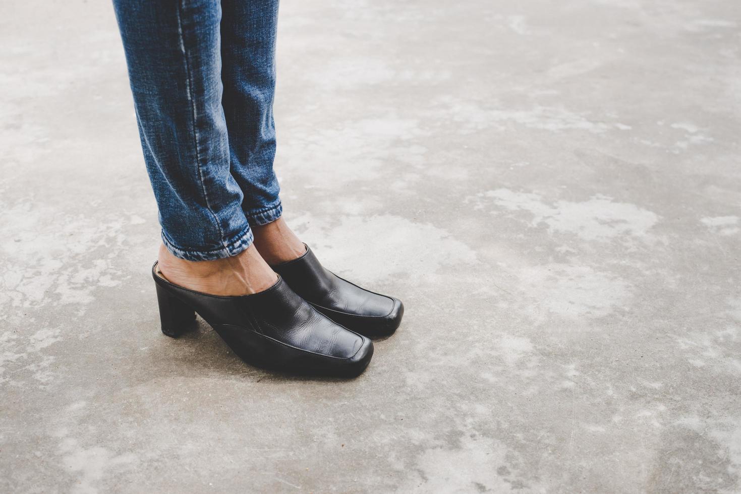 Woman's legs in denim jeans photo