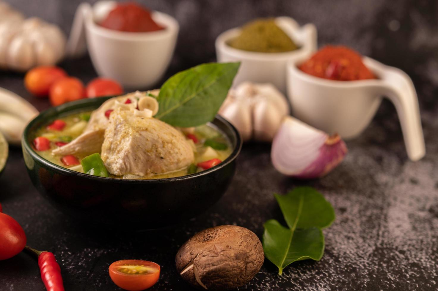 Green curry dish with chicken, chili and basil and tomato and lime photo