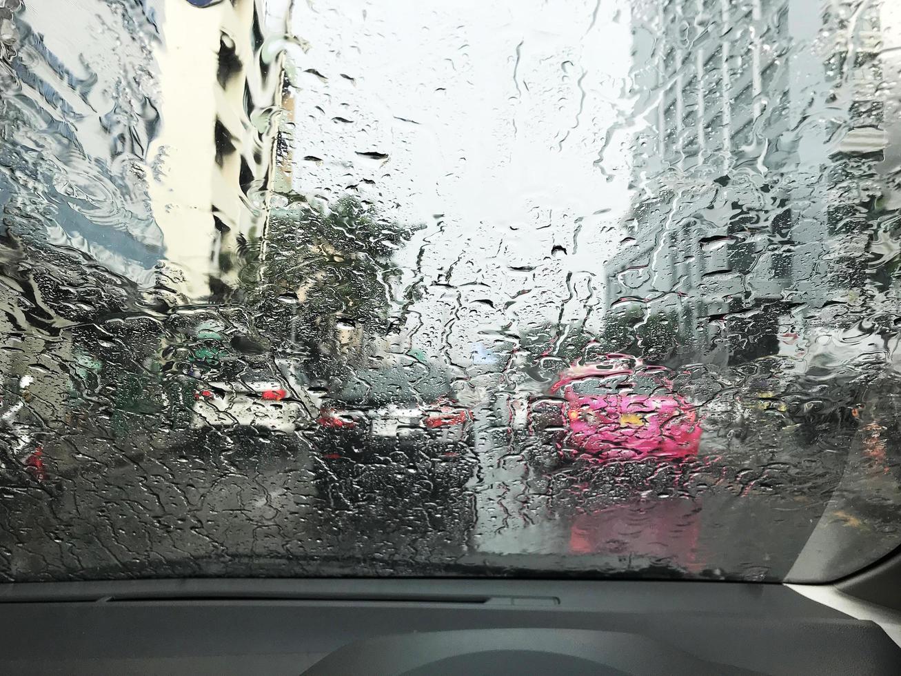 Road view through rainy windshield photo