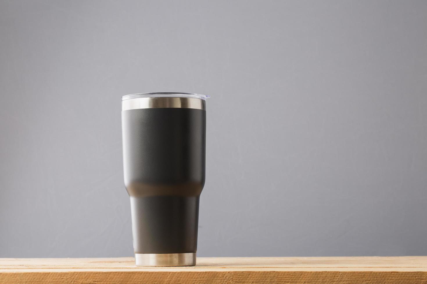 Black thermos on table photo