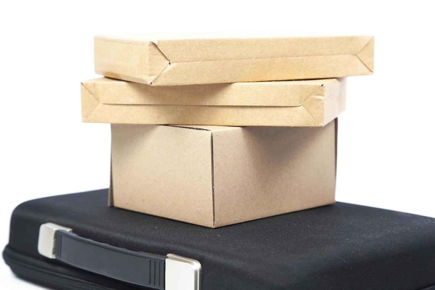 Brown paper boxes on a black briefcase photo