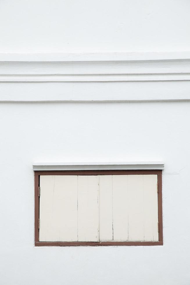 Old window on a white wall photo