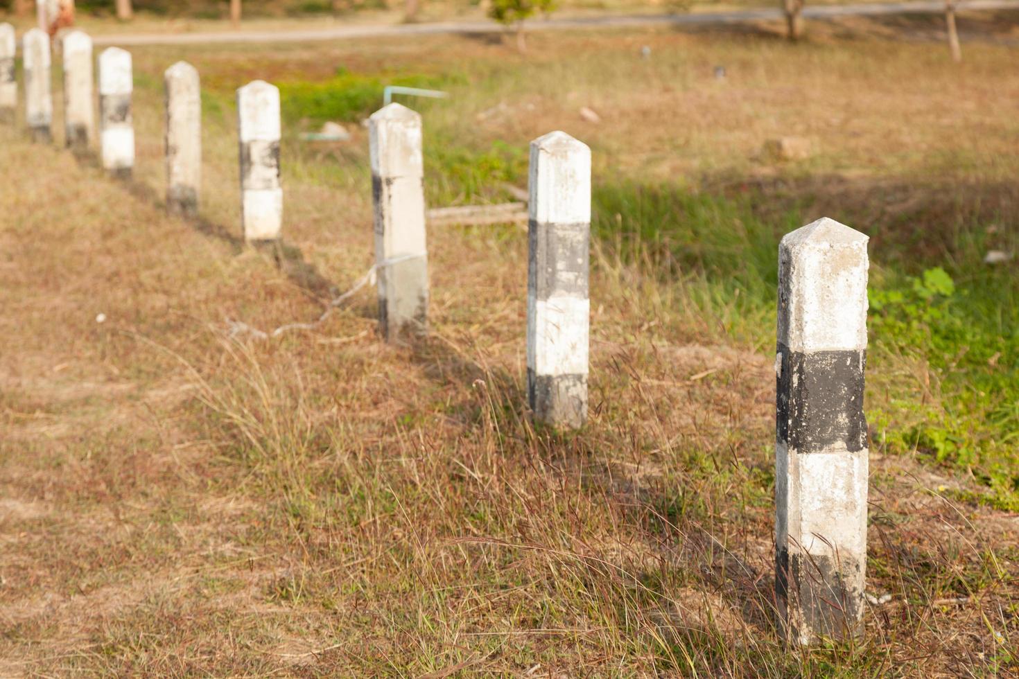 Cement poles beside the road photo