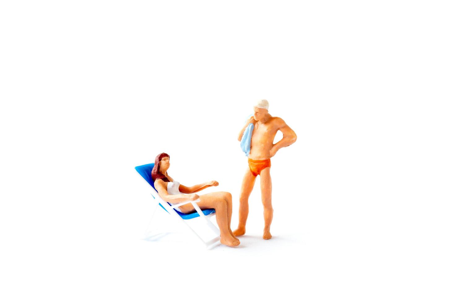 Two figurine people in swim suits photo