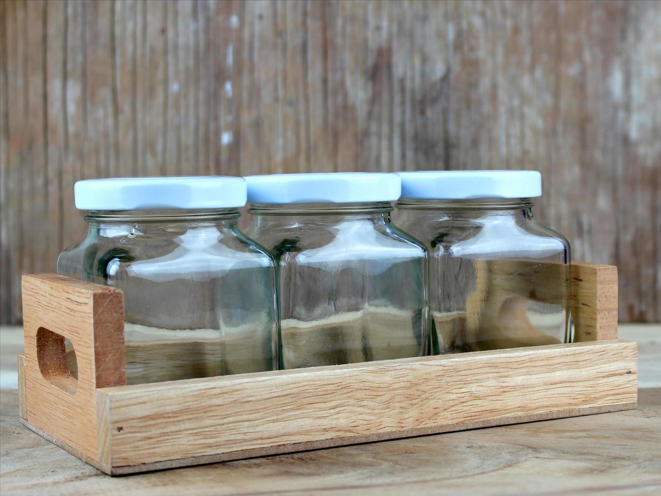 Three glass jars on tray photo