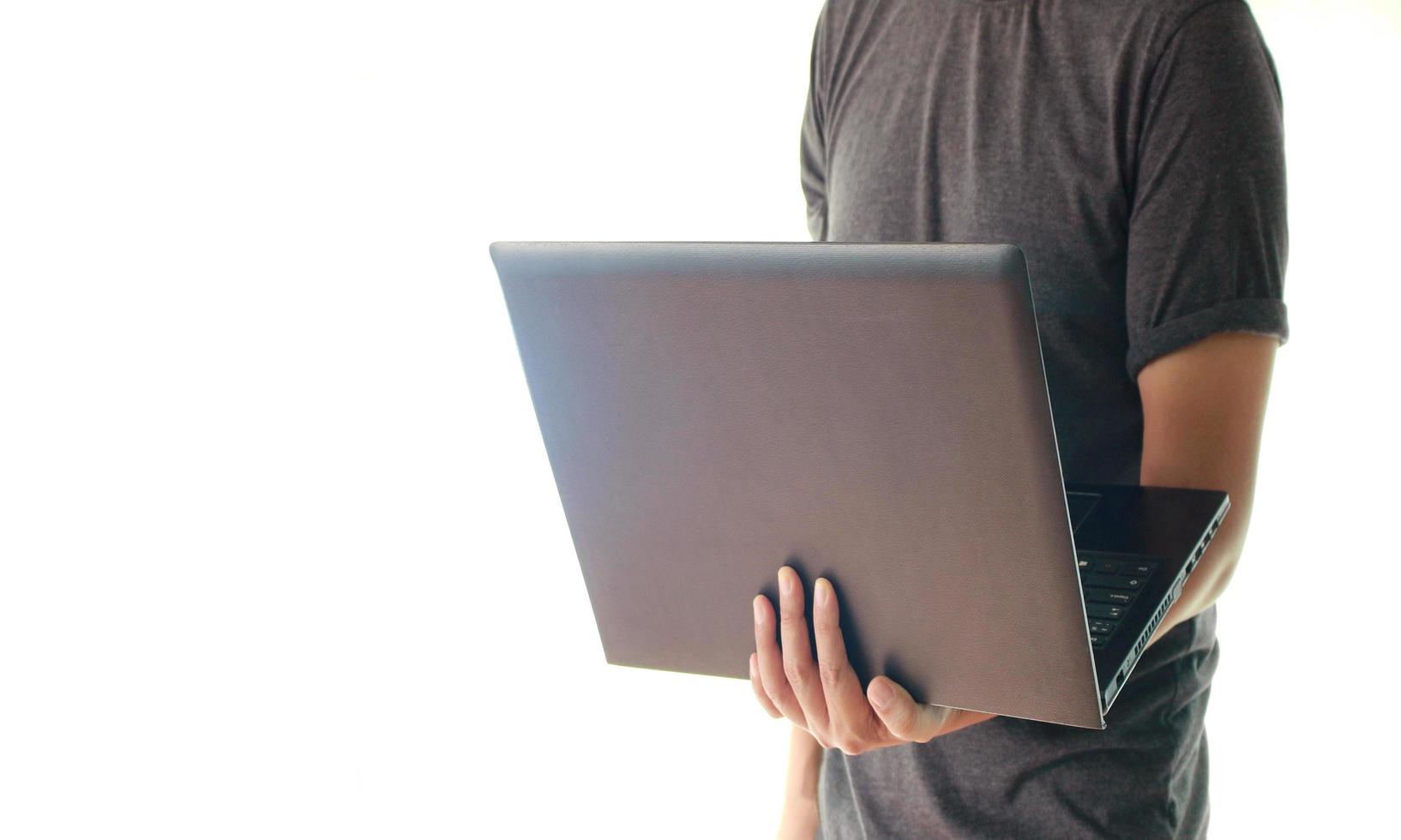 Man holding laptop photo