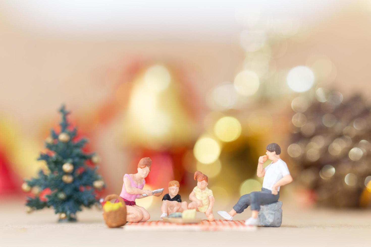 Miniature figurines of a family at Christmas time photo