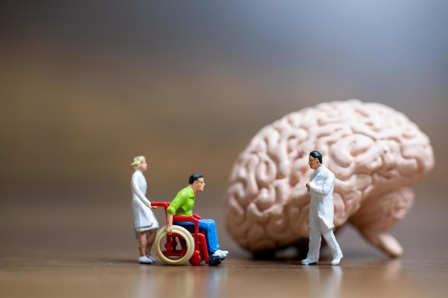 Miniature figurines of a surgeon speaking with patient photo