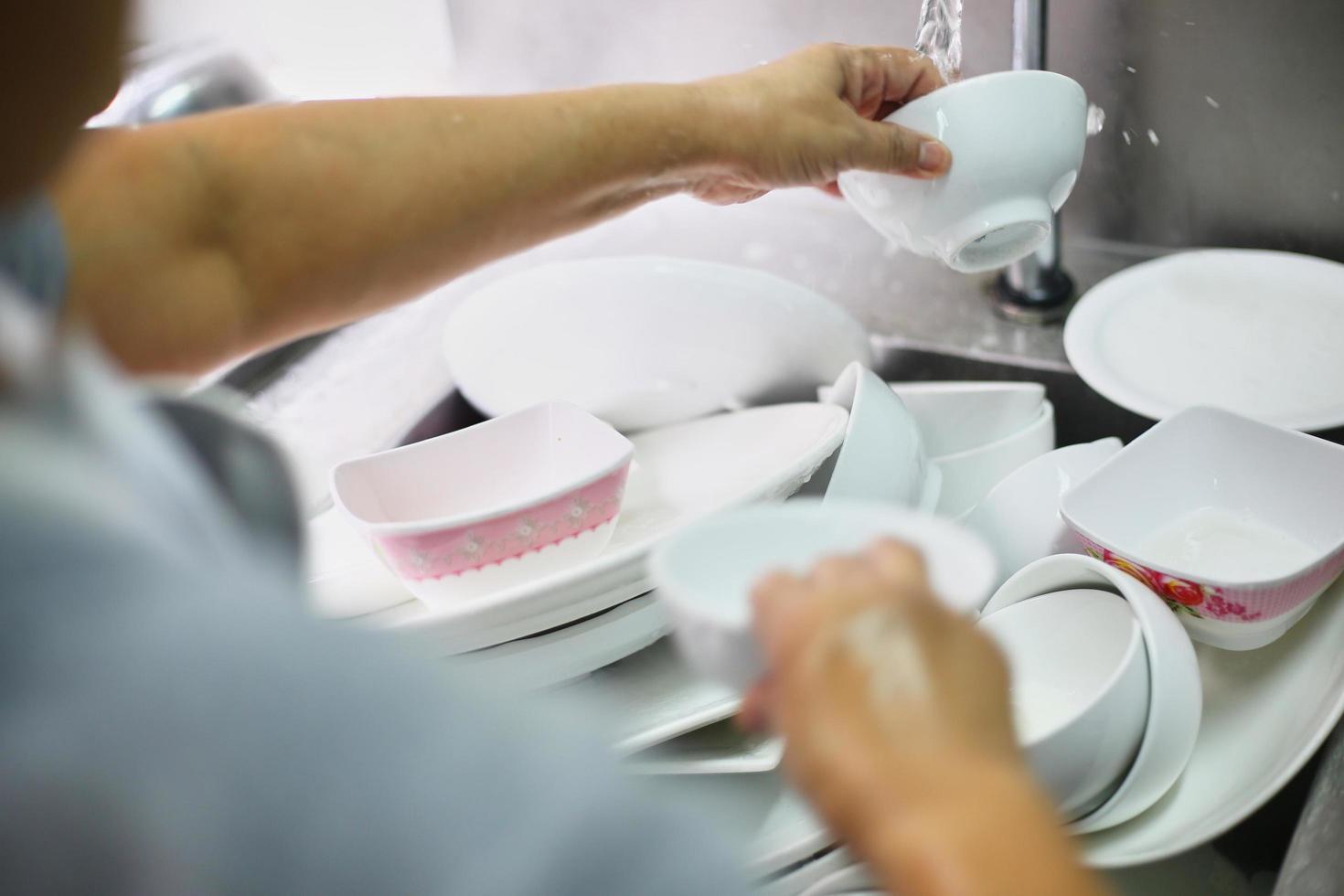 Washing pile of dishes photo