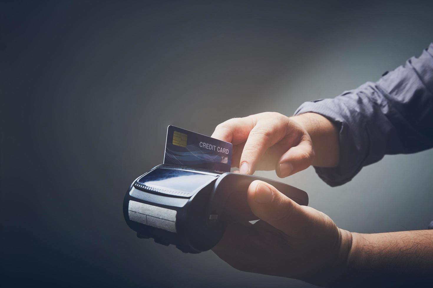 Person using a credit card machine photo