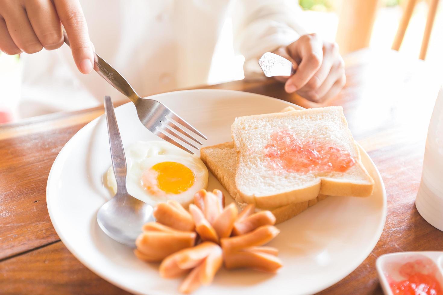 Toast, egg and sausages for breakfast photo