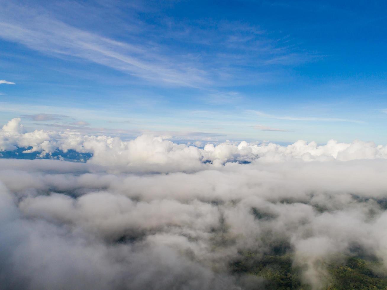 Top of mountain with view into misty valley photo