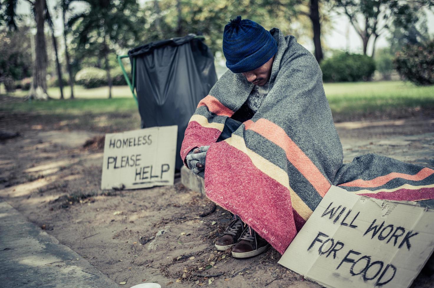 Homeless man with cardboard sign photo