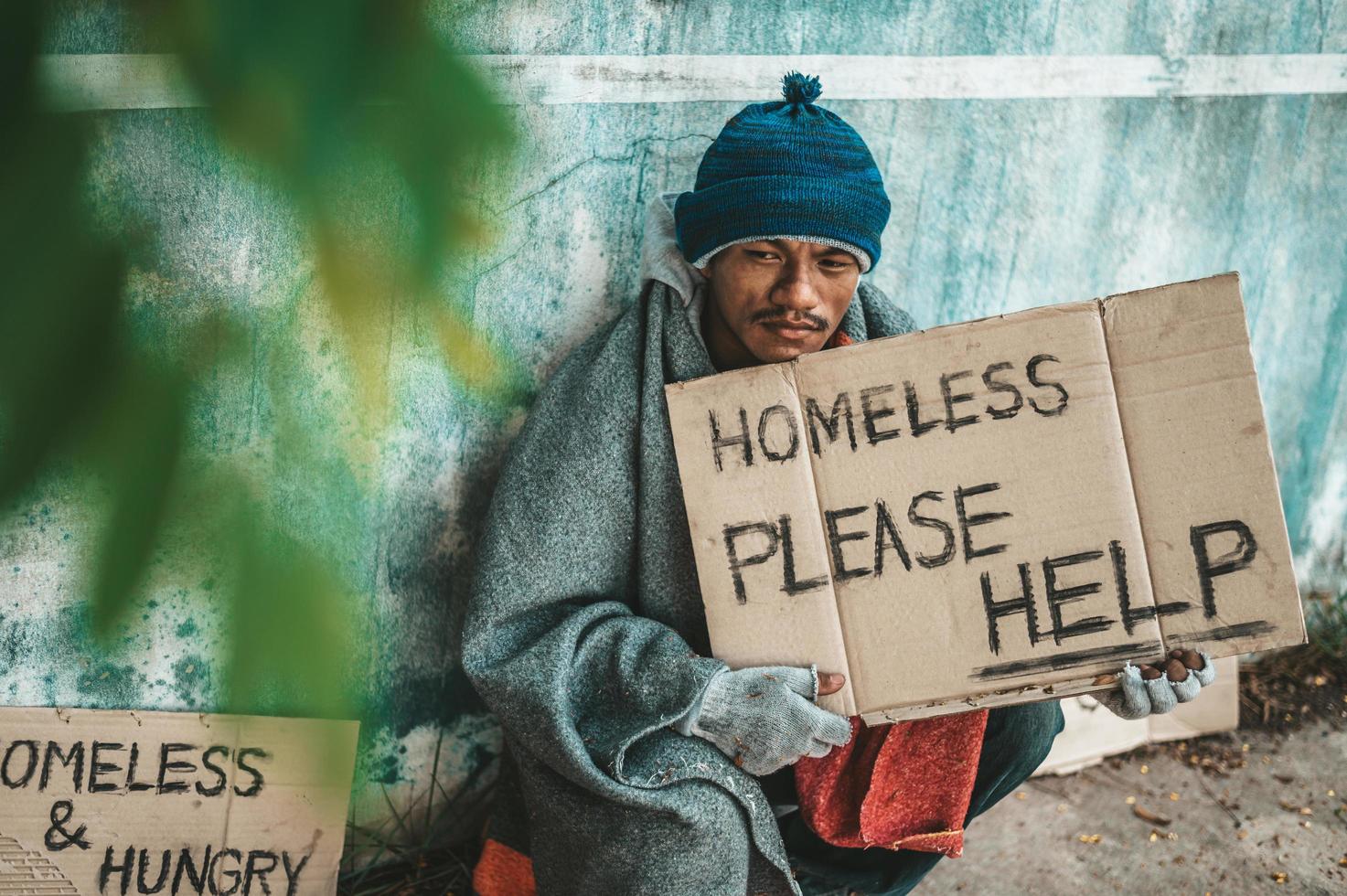 Person gives to a beggar on the side of the road photo