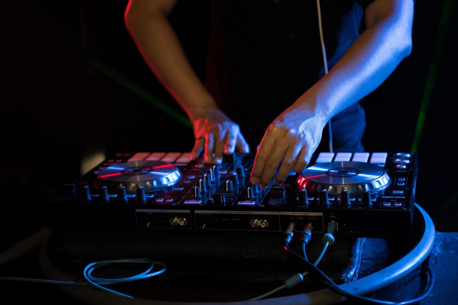 DJ playing turntable music at night club party photo