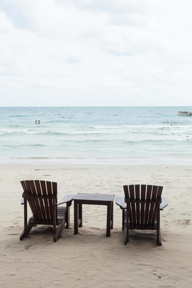 Chairs and table on the beach photo