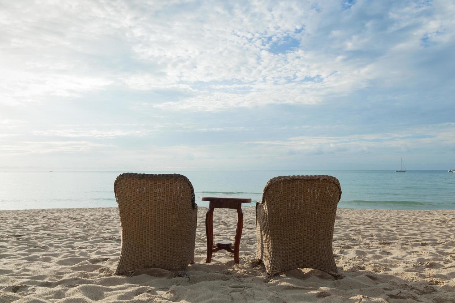 Chairs and table on the beach in Thailand photo