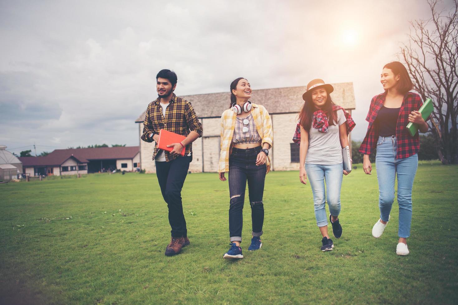 Group of students walking through the park after class photo