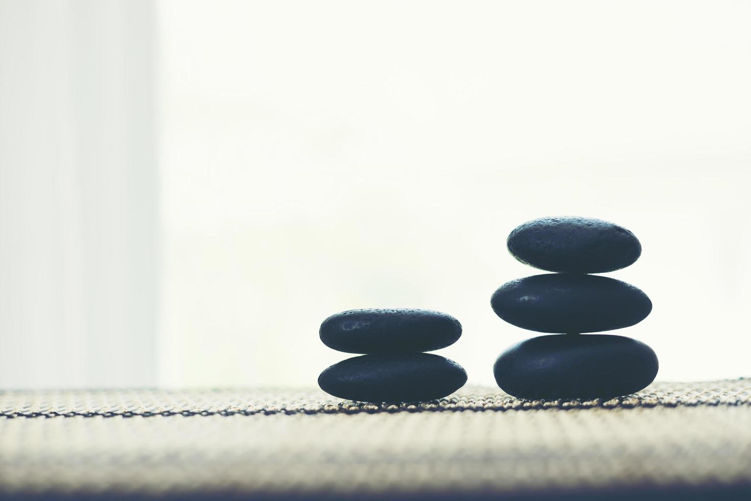 Stack of spa hot stones isolated on white background photo