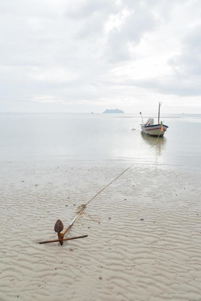 Anchor resting on the beach in Thailand photo