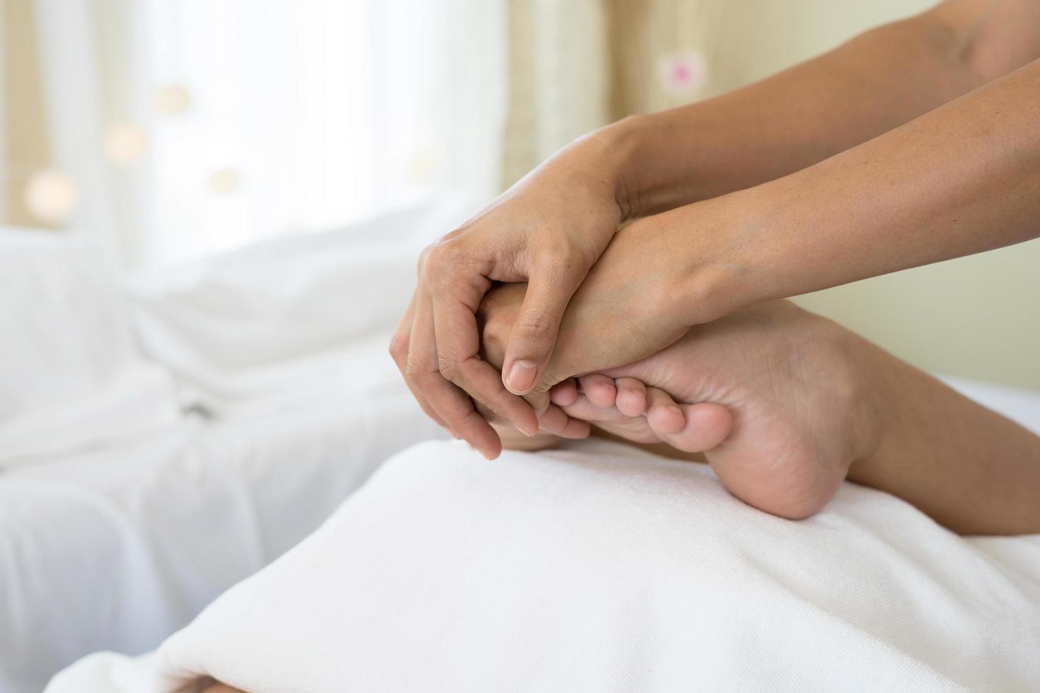 Close-up of woman doing foot massage at spa photo