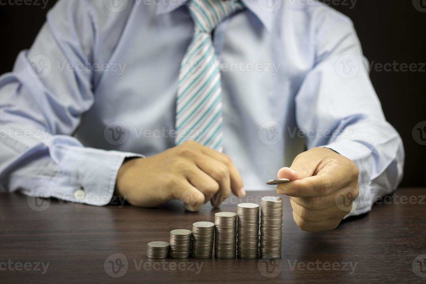 Business man stacking coins photo