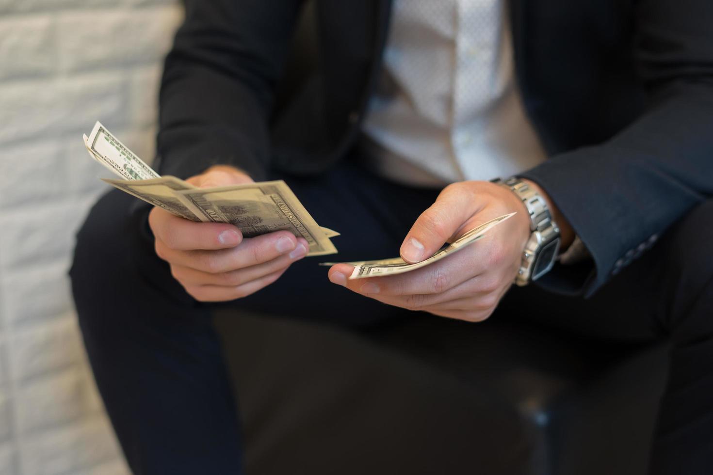 Portrait of a businessman holding money and counting it photo