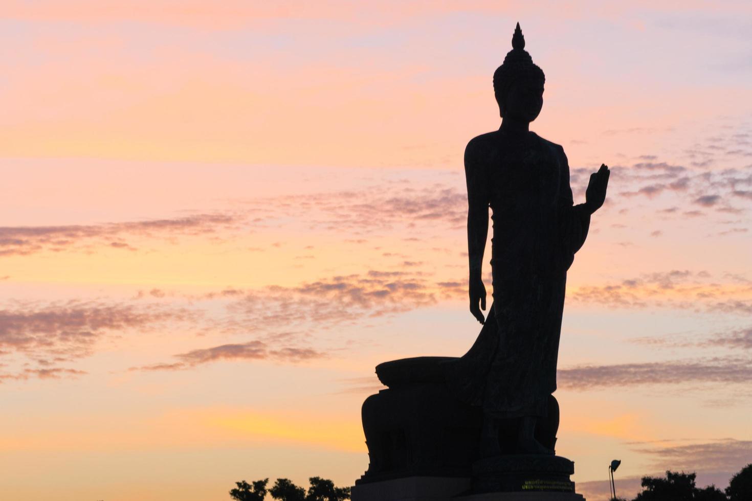 Silhouette of a large Buddha statue in Thailand photo