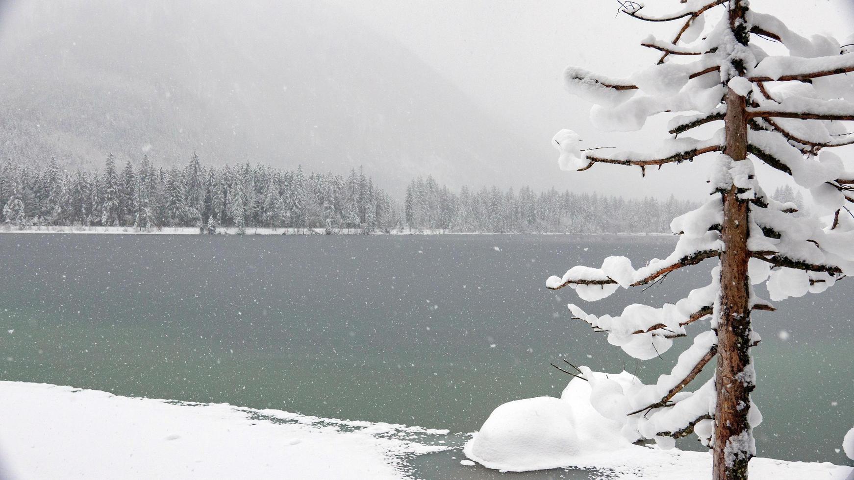 Scenic winter landscape by a frozen lake photo