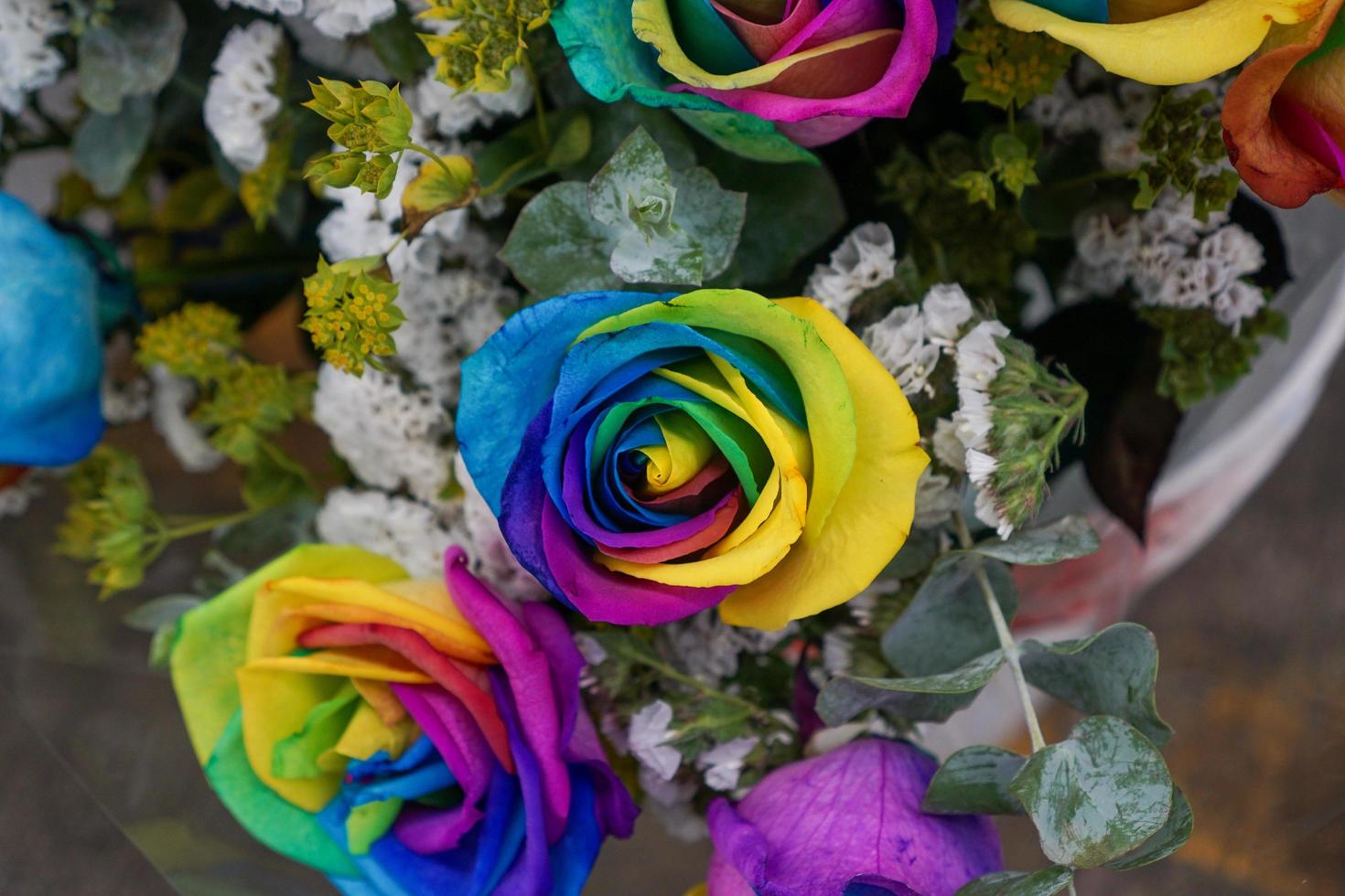 Rainbow-colored roses in bouquet photo