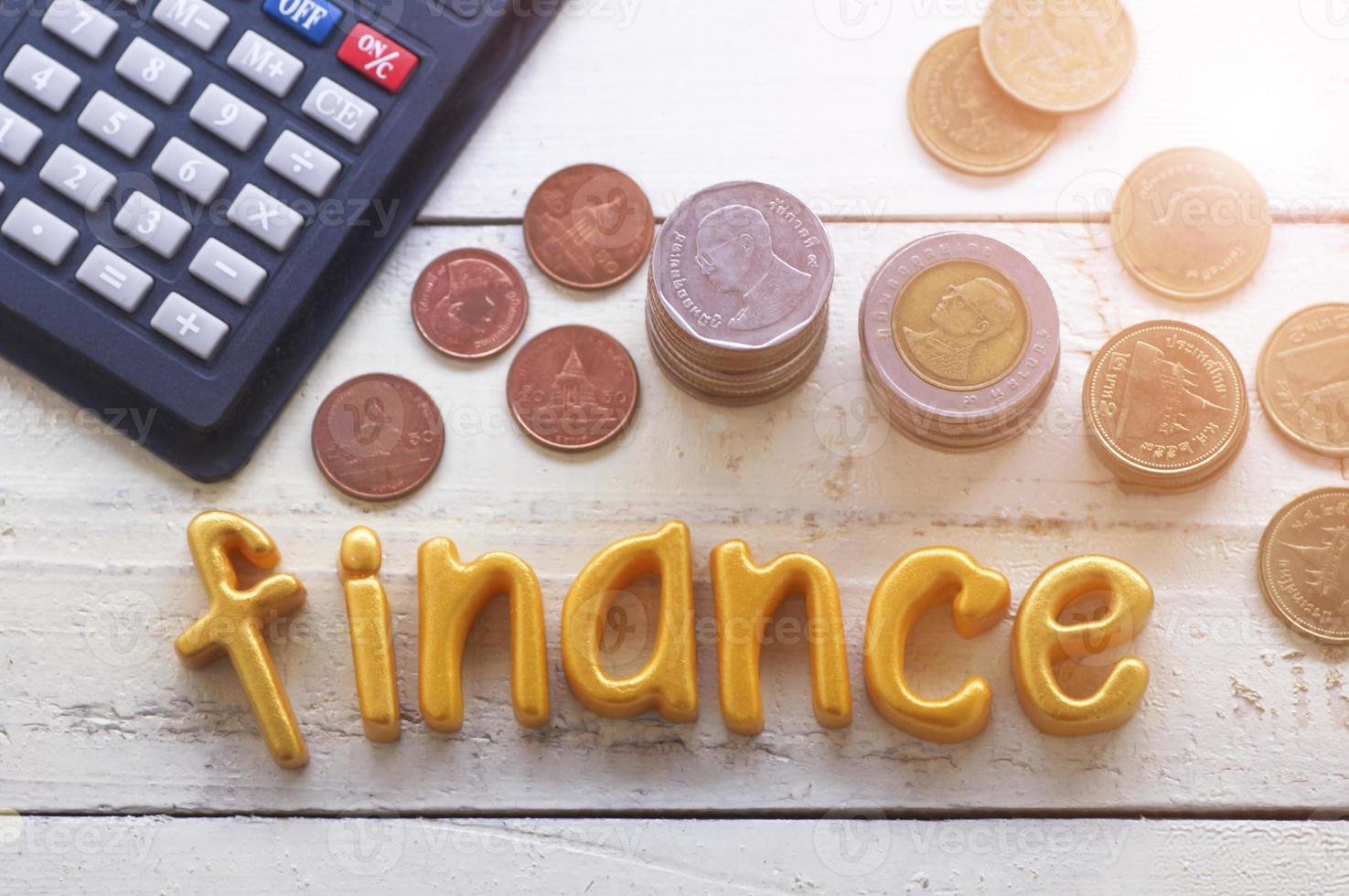 Finanzas palabra sobre mesa de madera con monedas foto