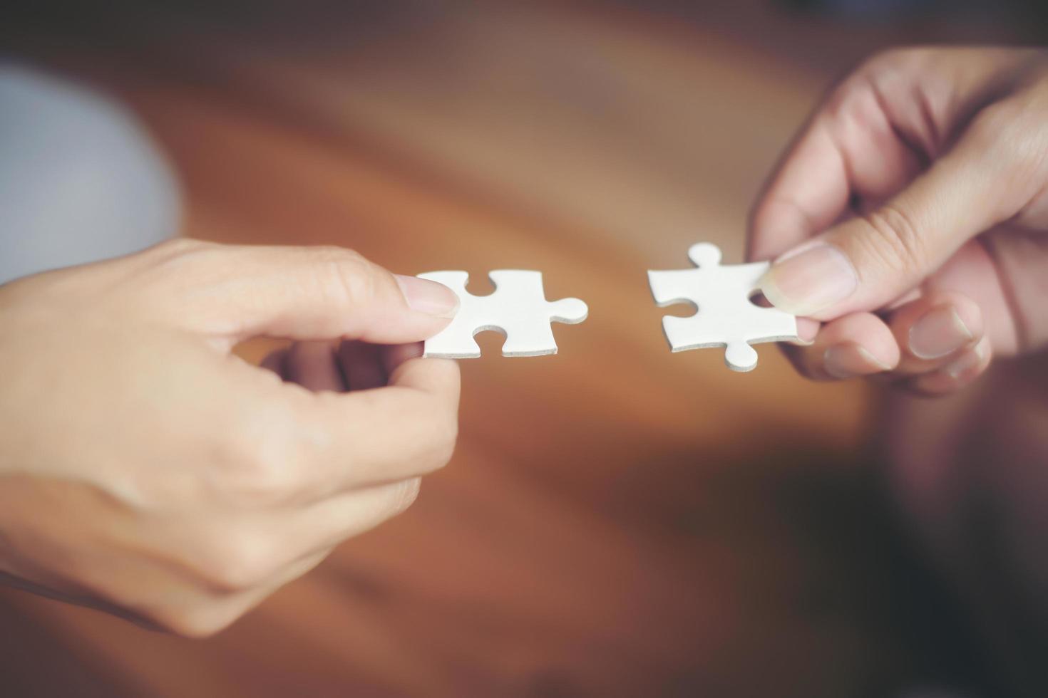 Hands holding jigsaw puzzles photo