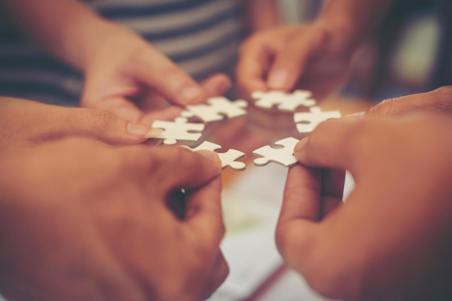 Hands holding jigsaw puzzles photo