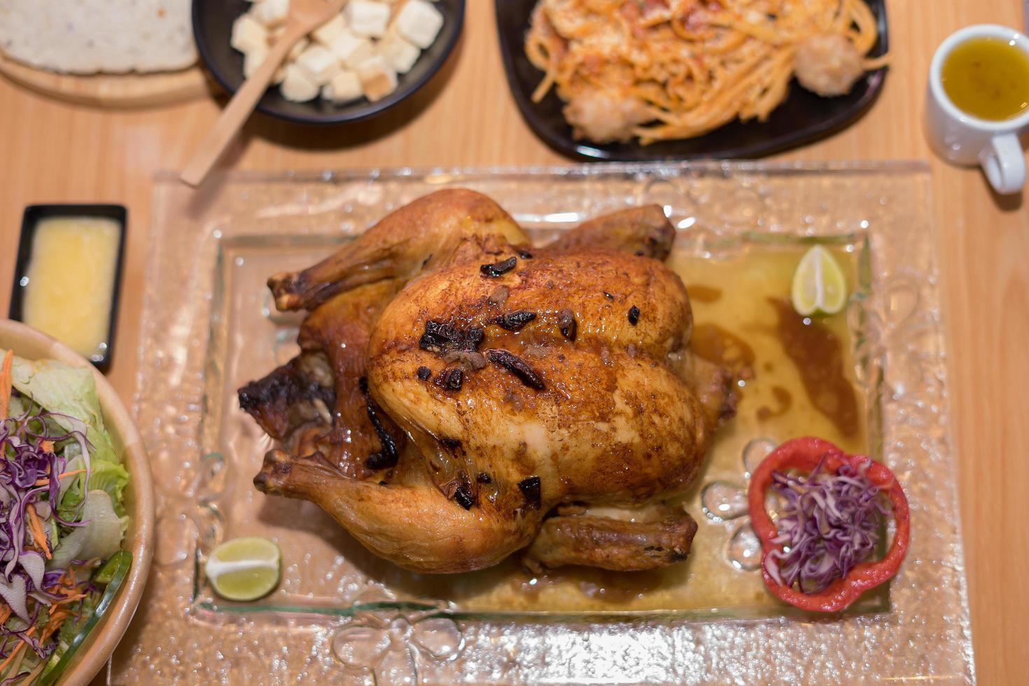 Baked whole chicken on a plate photo