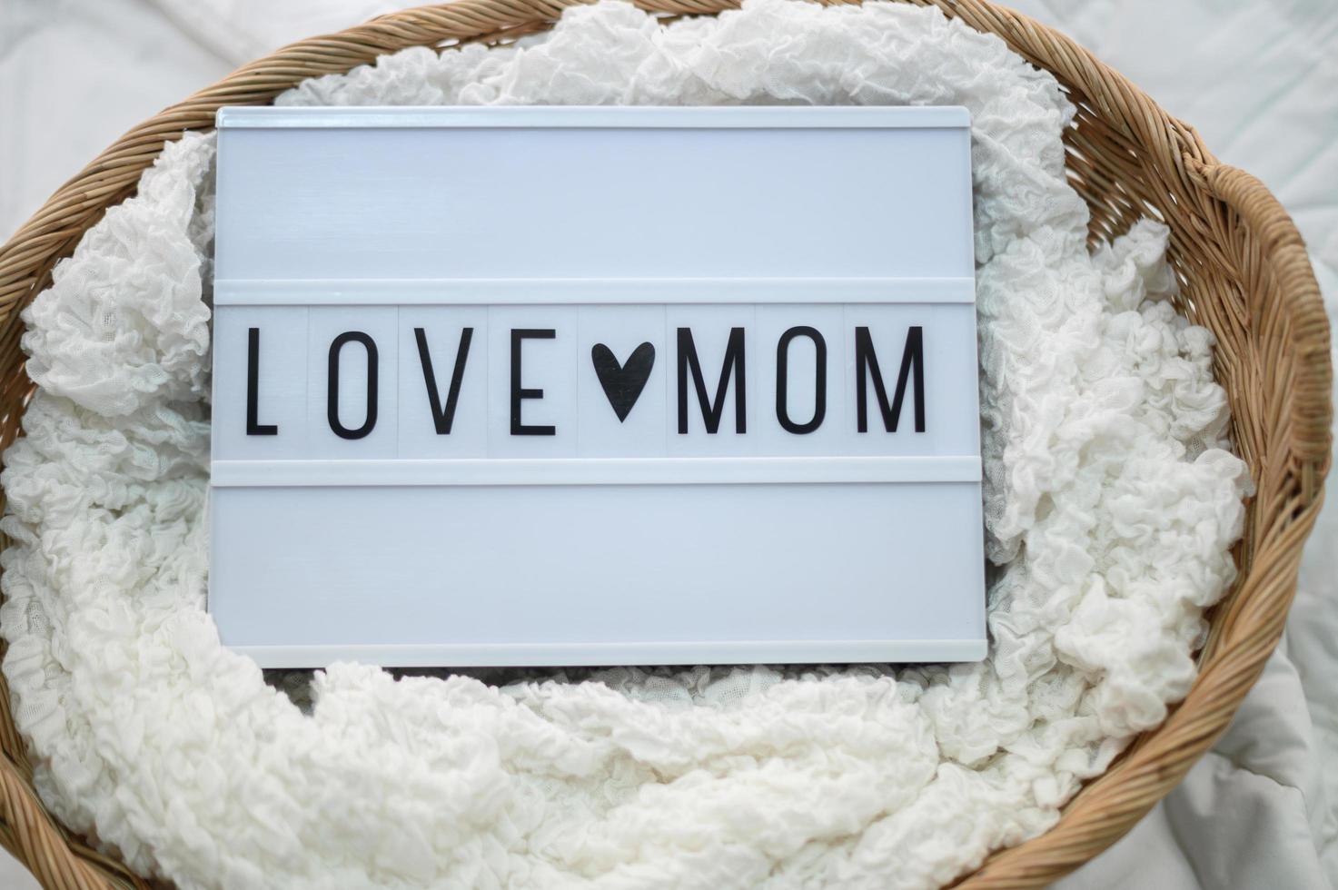 Wooden basket with fabric and love mom sign photo