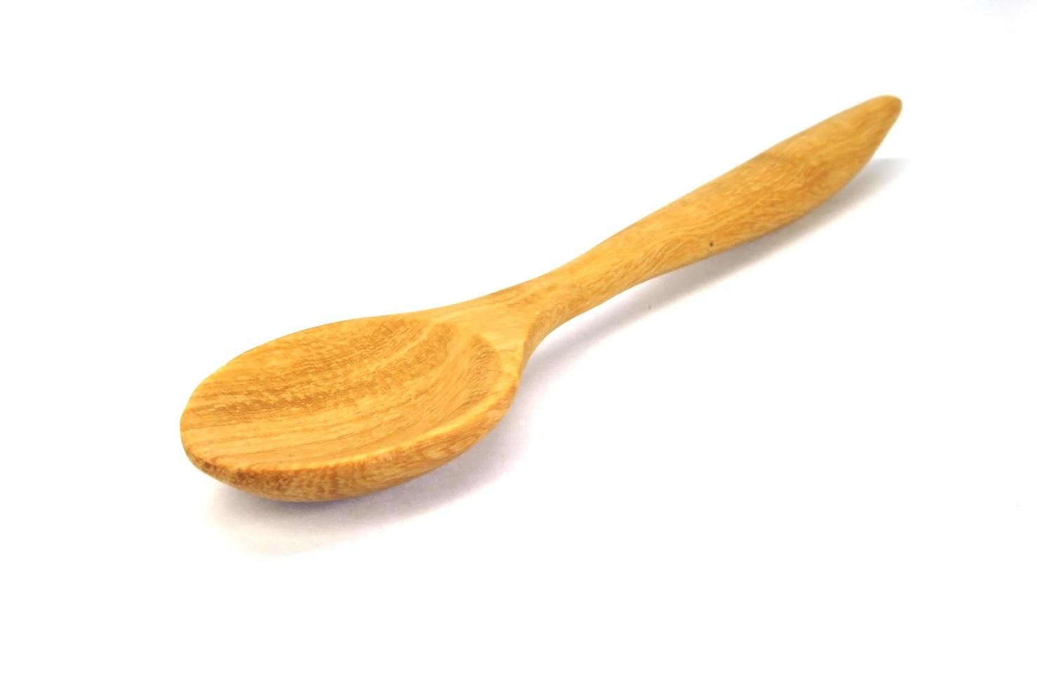 Wooden spoon on a white background photo