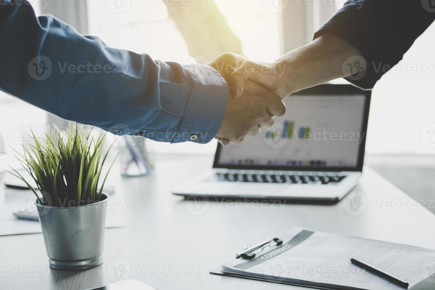 Businessmen shaking hands after finishing meeting photo