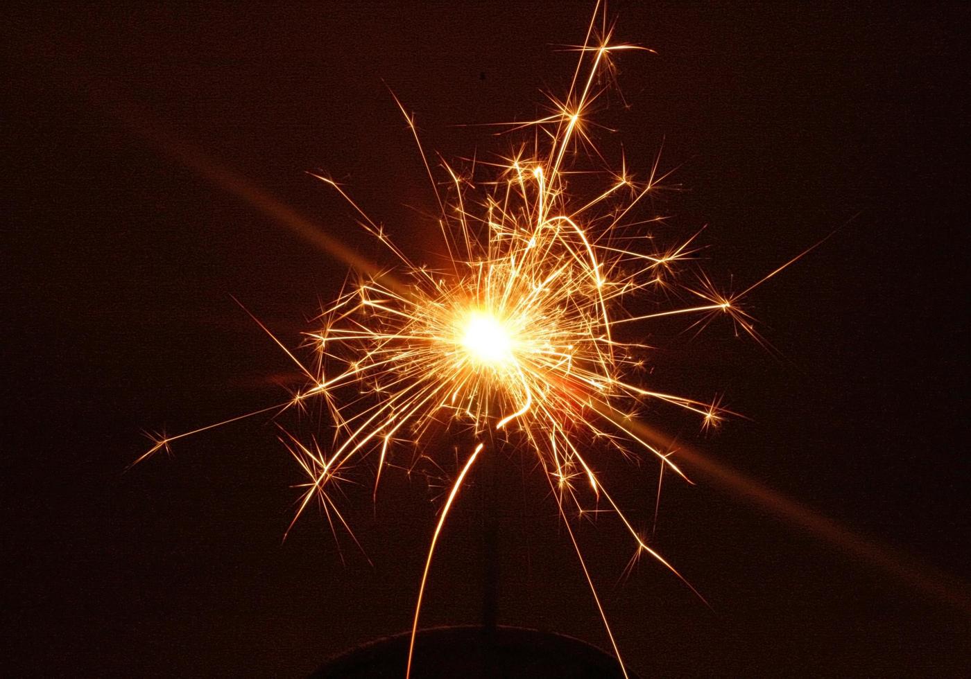 Sparkler glowing at night photo